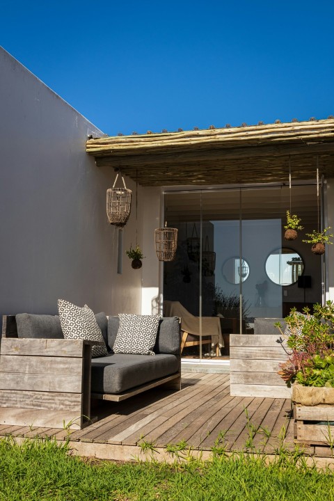 a couch sitting on top of a wooden deck