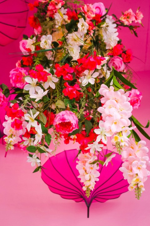 pink and white flowers on red table C