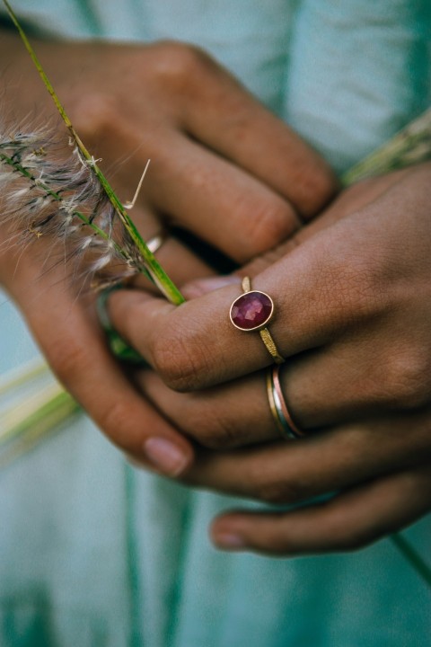 a close up of a person holding a flower