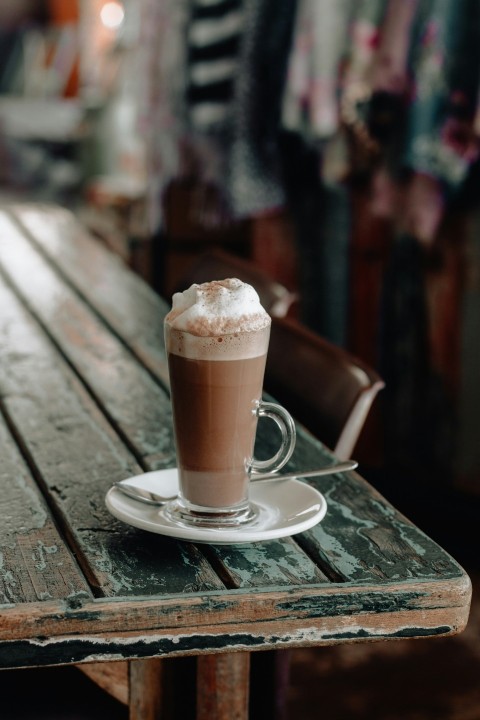 shallow focus photo of chocolate drink in clear glass mug