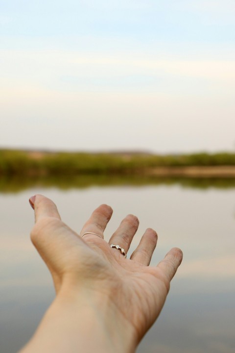 person wearing silver colored ring