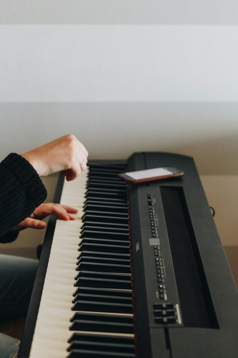 person playing electronic keyboard