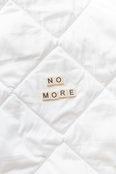 a close up of a white quilt with words written on it