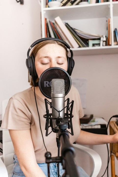 man in white crew neck t shirt wearing black headphones