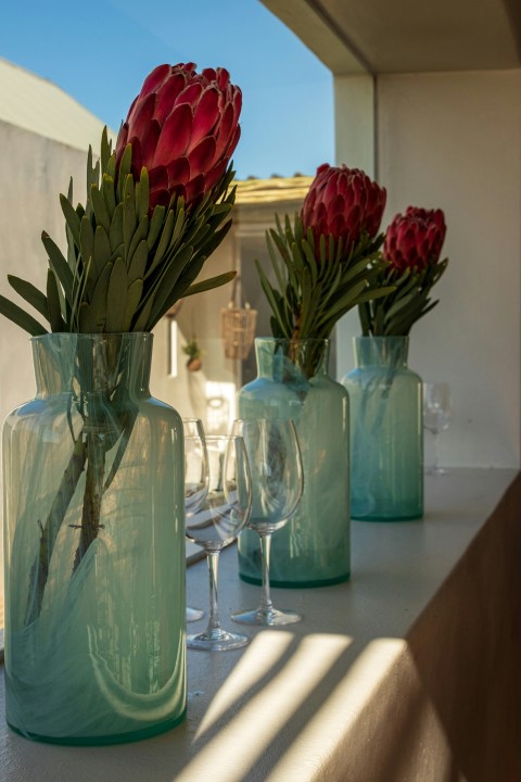 a group of vases with flowers in them on a table