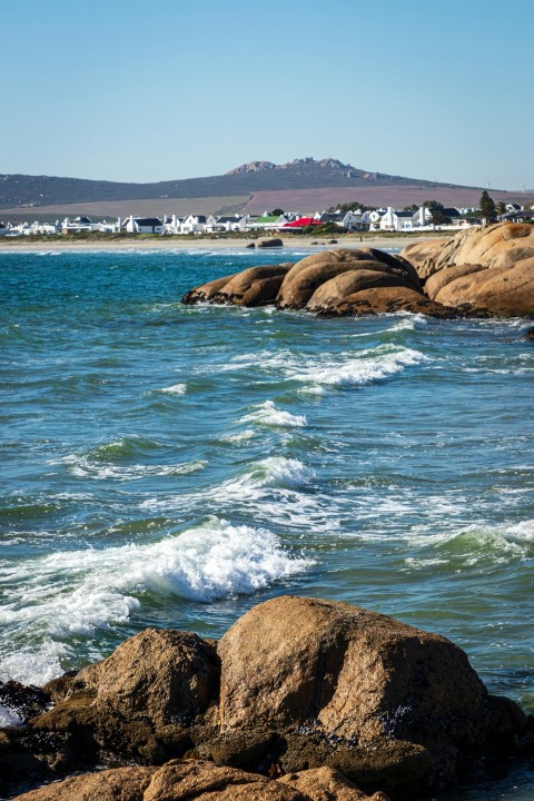 a view of a body of water with rocks in the foreground