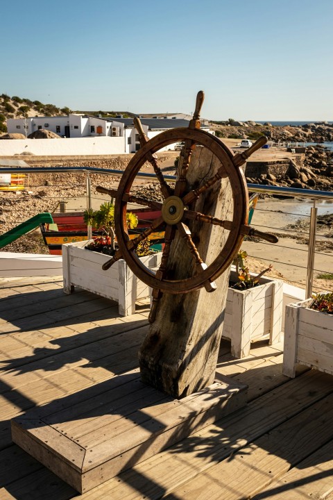 a wooden deck with a ship wheel on it