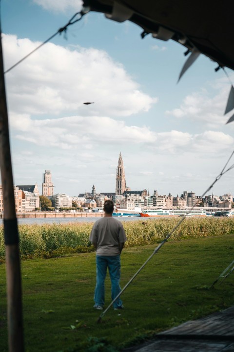 a man standing on top of a lush green field 3scEpJb