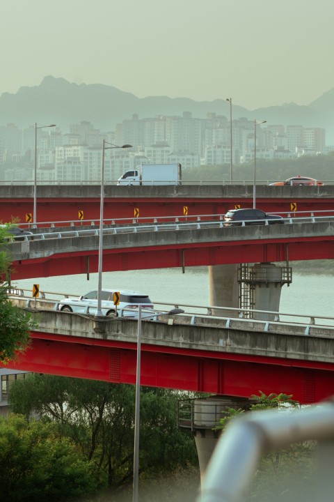 a red bridge over a body of water