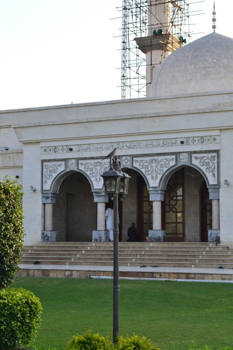 a large white building with a clock tower in the background k