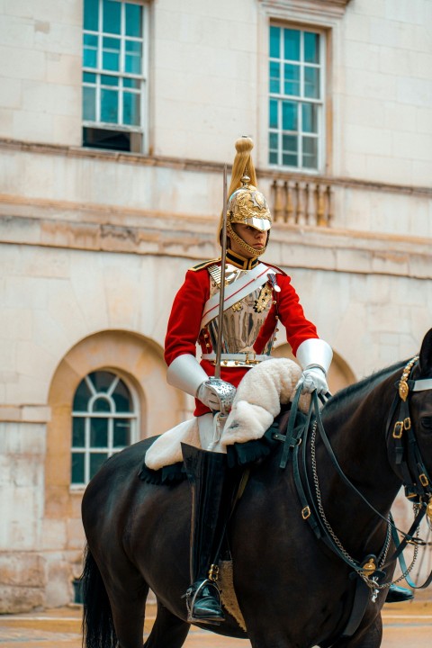 a man in a uniform riding a horse