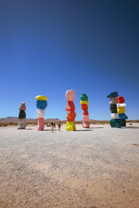 a group of people standing in the middle of a desert