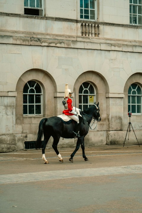 a person riding a horse in front of a building