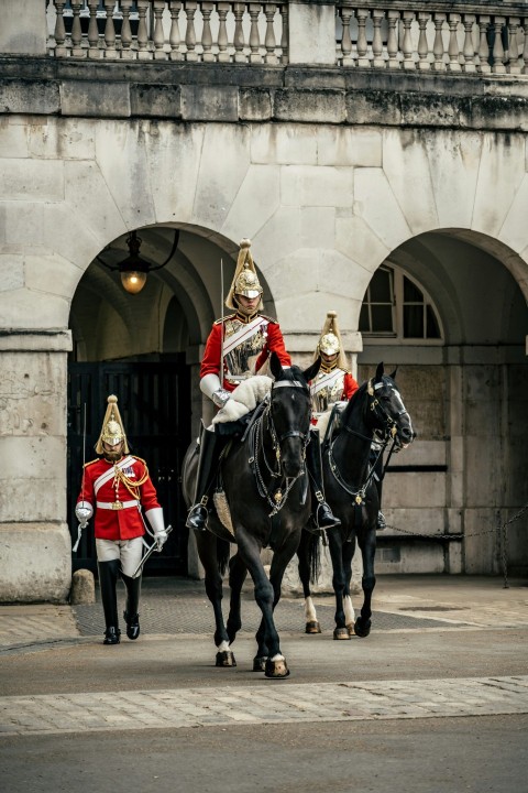 a couple of men riding on the backs of horses