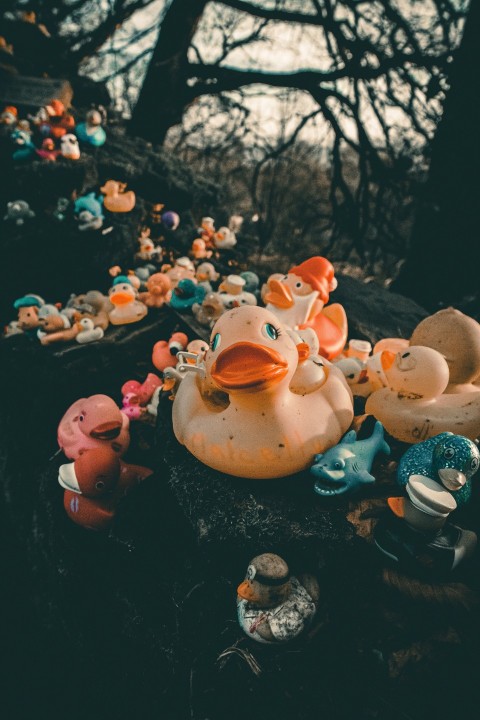 a pile of rubber ducks sitting on top of a tree stump