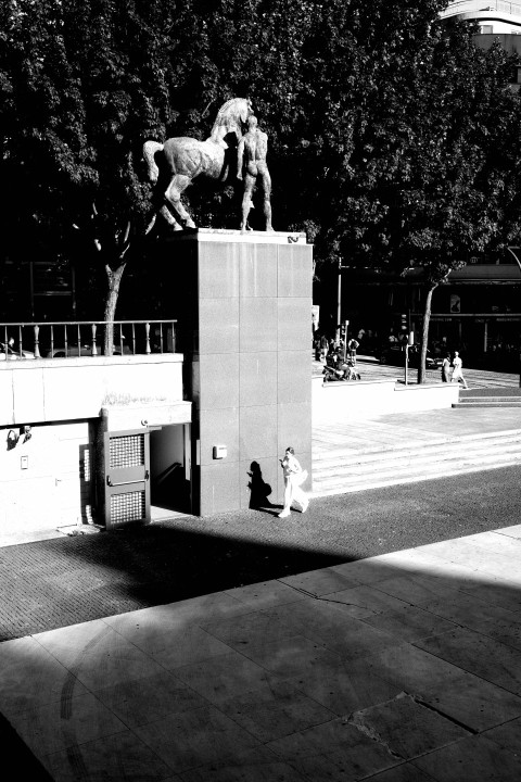 a black and white photo of a statue of a horse and rider