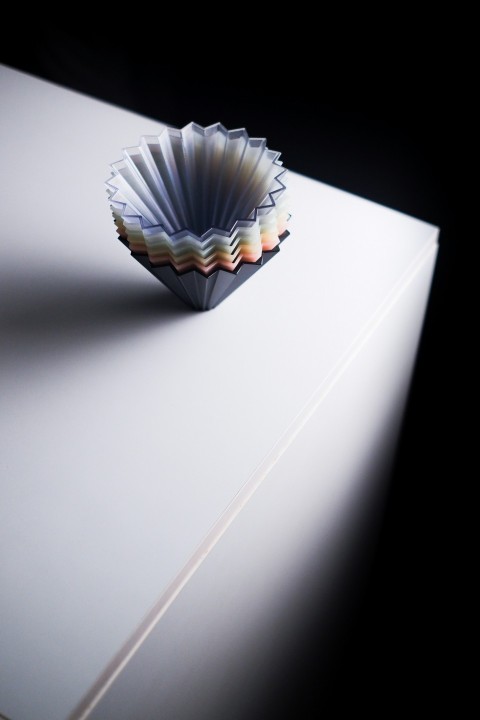 a paper cup sitting on top of a white table