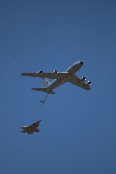 a large jetliner flying through a blue sky