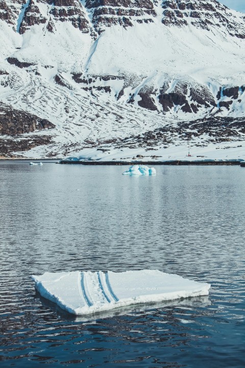 an iceberg floating in the middle of a lake