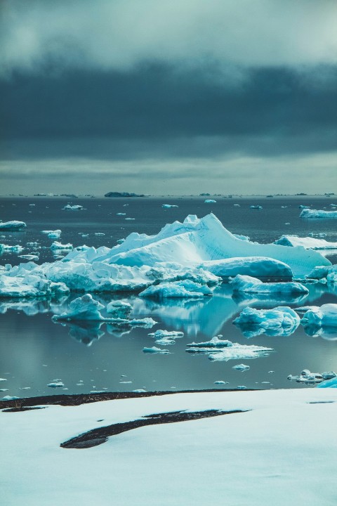 a large iceberg floating on top of a body of water