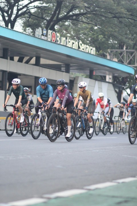 a group of people riding bikes down a street