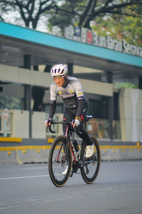 a man riding a bike down a street