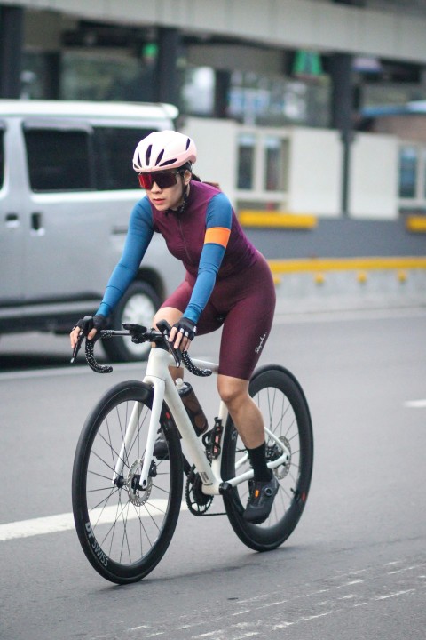 a man riding a bike down a street