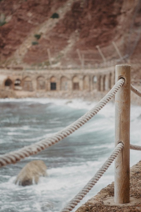 a man standing next to a body of water