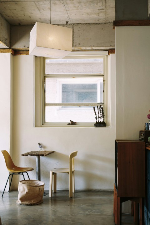 a room with a table chairs and a window mbvLnN