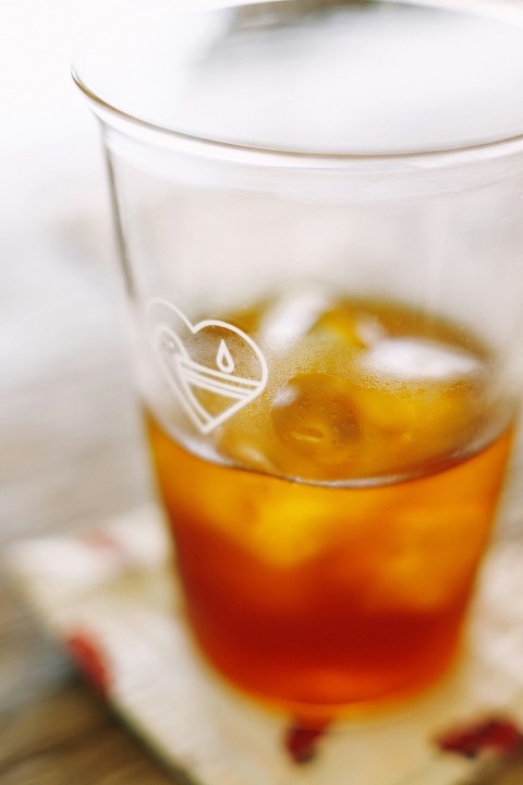 a glass of tea on a napkin on a table Wi3