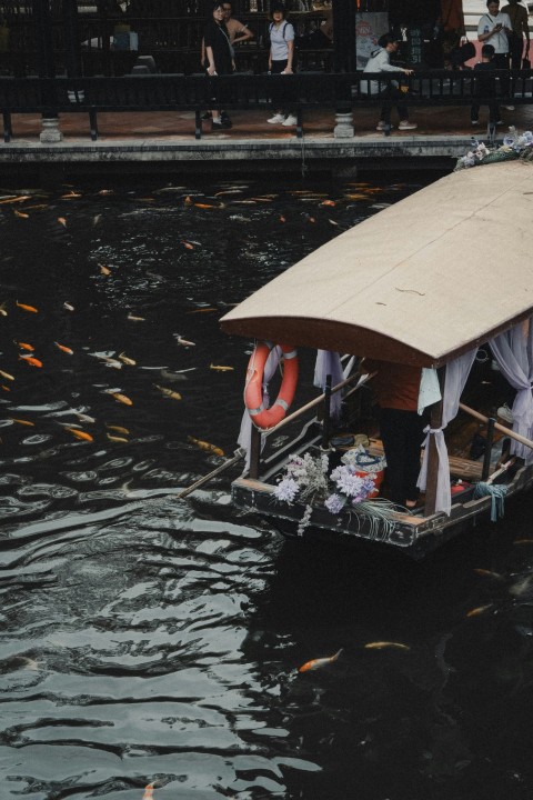 a boat with people on it floating down a river