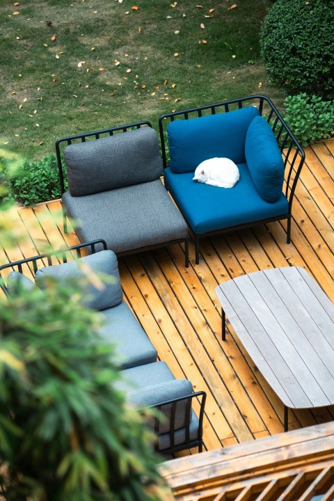 a deck with a couch table and chairs