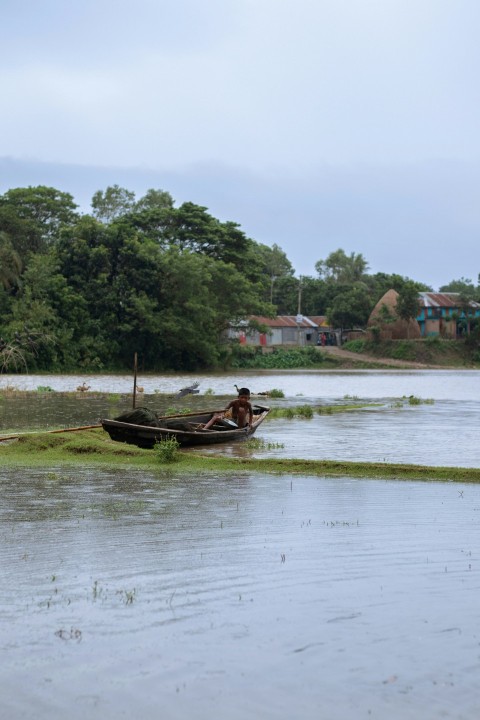 a boat sitting in the middle of a river