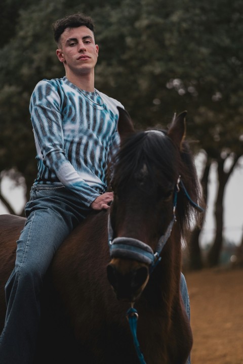 a man riding on the back of a brown horse