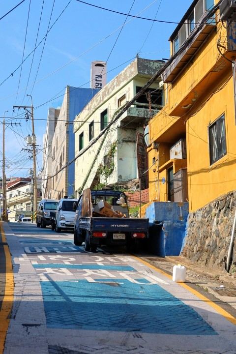 a city street with cars parked on the side of it