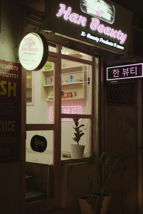 a store front with a plant in the window