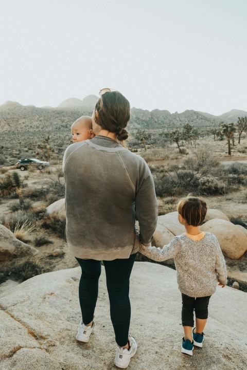 man and woman walking on gray sand during daytime