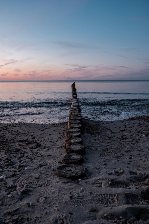 gray concrete stairs on beach during sunset