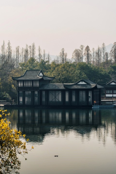 brown and white house near body of water during daytime