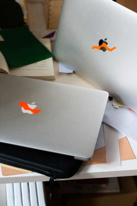 silver macbook on brown wooden table