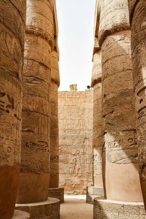 a group of large stone pillars with carvings on them