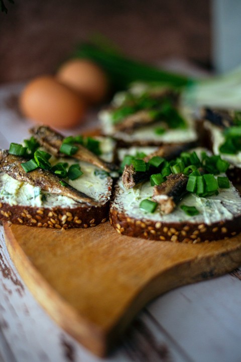 a wooden cutting board topped with slices of bread