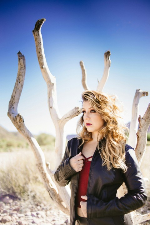 woman standing beside bare tree Rayeh_7Q