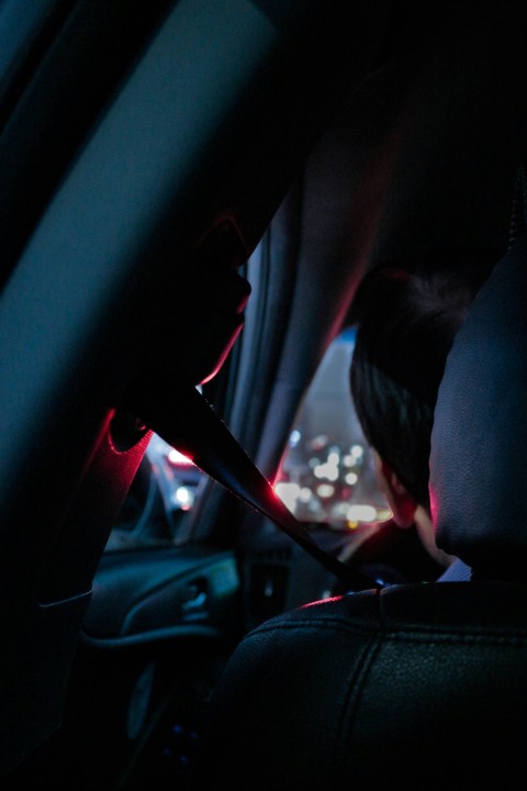 man sitting on drivers seat close up photography