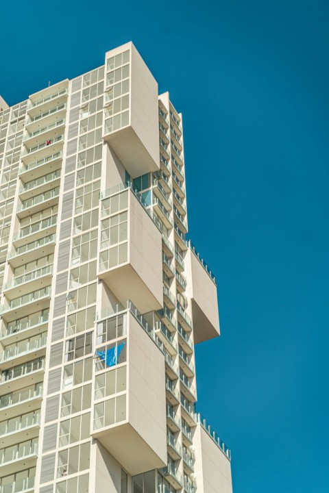 a tall building with balconies on the top of it