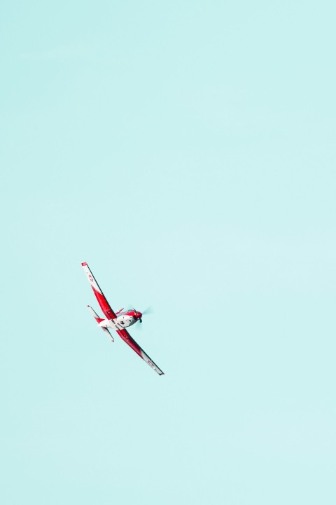 flying red and white biplane V