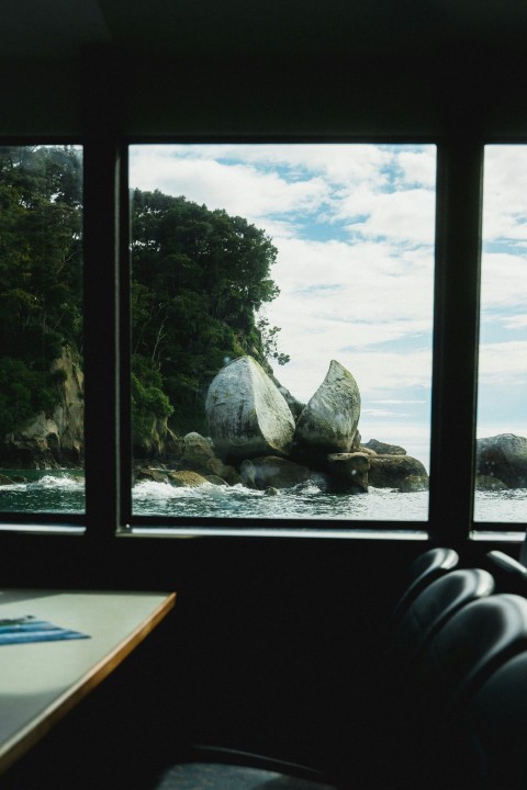 a room with a view of the water and rocks