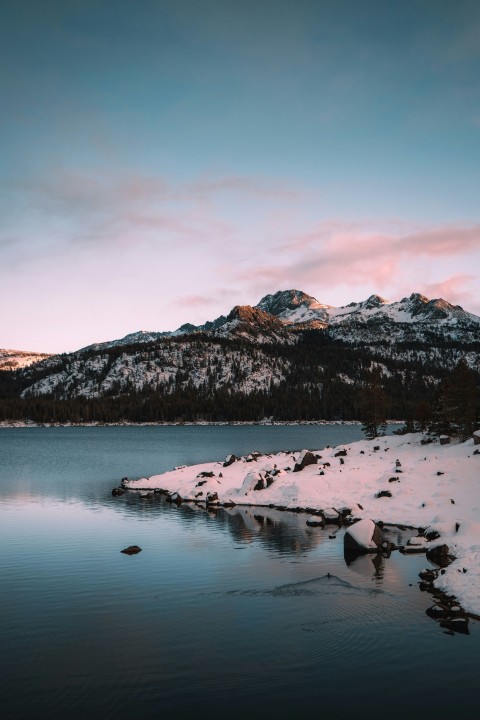 snow covered mountain near lake during daytime 8vzh