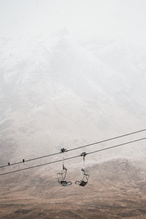 a couple of ski lifts sitting on top of a snow covered mountain