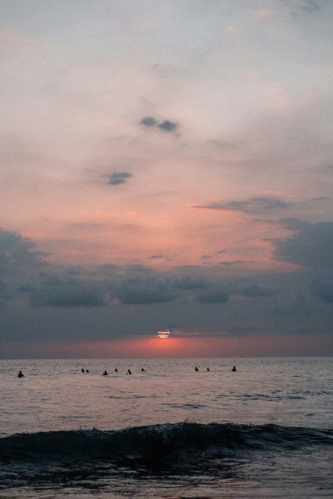 body of water under cloudy sky during sunset WOjmg2F